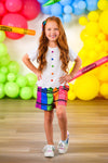 Crayon Short Set - 3T - Girl wearing a white short-sleeve top with colorful crayon dot buttons and vibrant, multicolored crayon-patterned shorts.