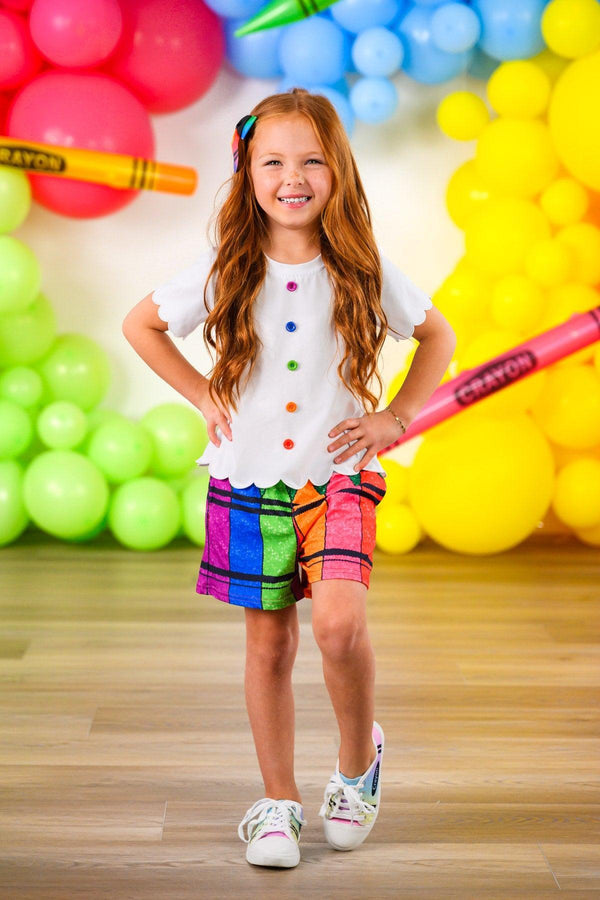 Crayon Short Set - 3T - Girl wearing a white short-sleeve top with colorful crayon dot buttons and vibrant, multicolored crayon-patterned shorts.