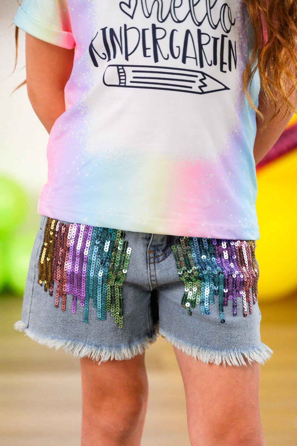 "Hello Pre-K - 6th Grade" Rainbow Denim Short Set - PRE-K / 2T - Light wash denim shorts with multicolored sequin fringe and raw hem detailing.