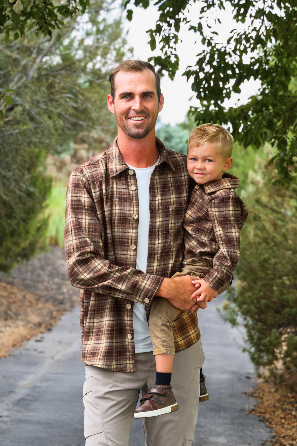 Family Brown Dress & Flannel - GIRL-6-12 Months-FAMILY - Men's and toddler brown plaid flannel shirts with button-up fronts and collars, worn outdoors.