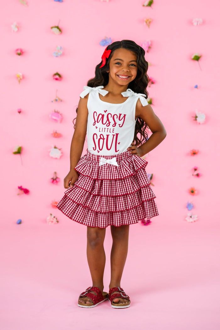 "Sassy Little Soul" Red Gingham Skirt Set - 6-12 Months - White sleeveless top with red "Sassy Little Soul" text paired with red gingham tiered ruffle skirt and matching bow headband.