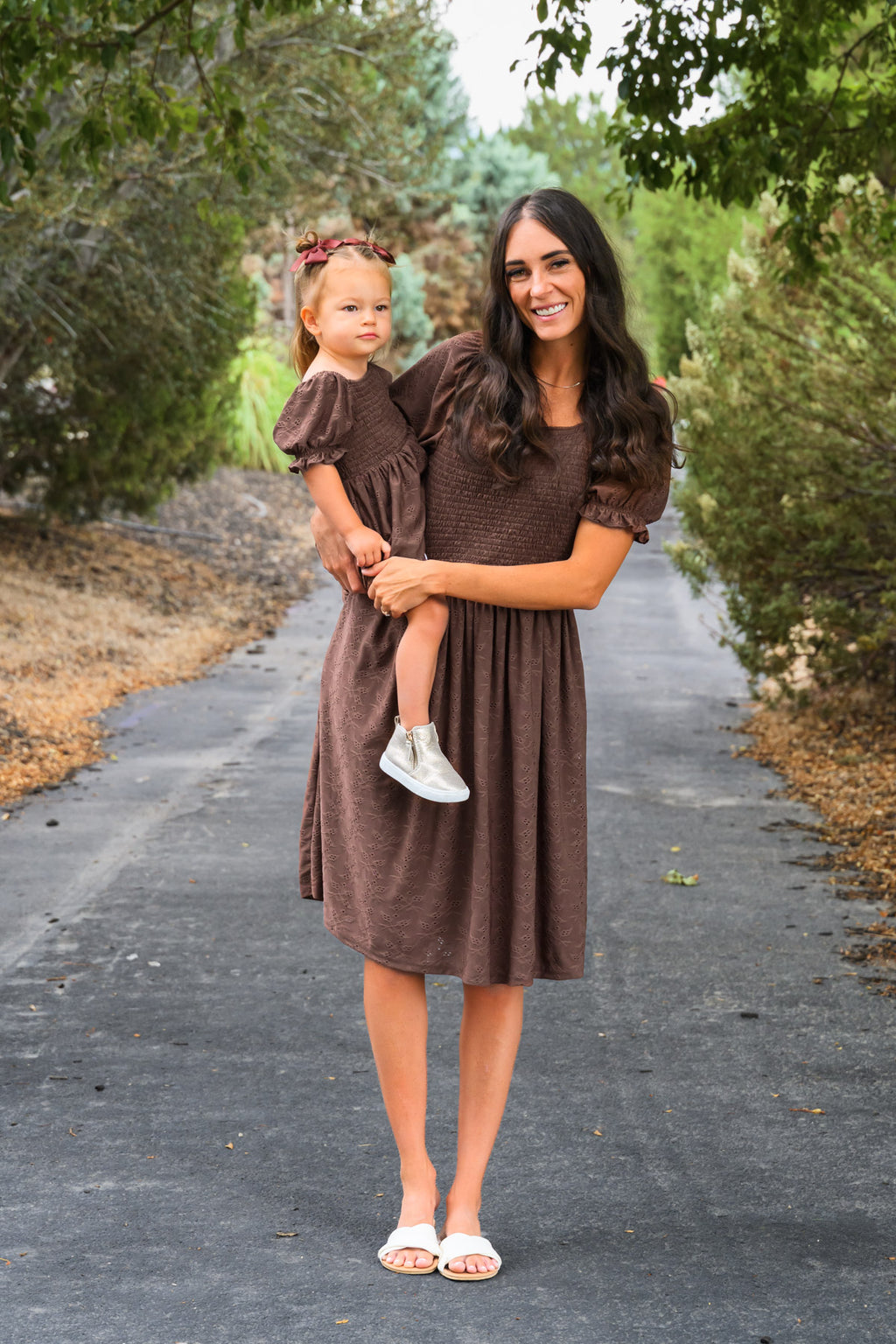 Family Brown Dress & Flannel - GIRL-6-12 Months-FAMILY - Brown knee-length dress with puff sleeves worn by woman holding toddler in matching brown dress with puff sleeves and white.