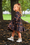 Family Navy & Rust Plaid Dress & Shirt - GIRL-0-3 Months-FAMILY - Navy and rust plaid long-sleeve dress with tiered skirt on a young girl, paired with white high-top sneakers.