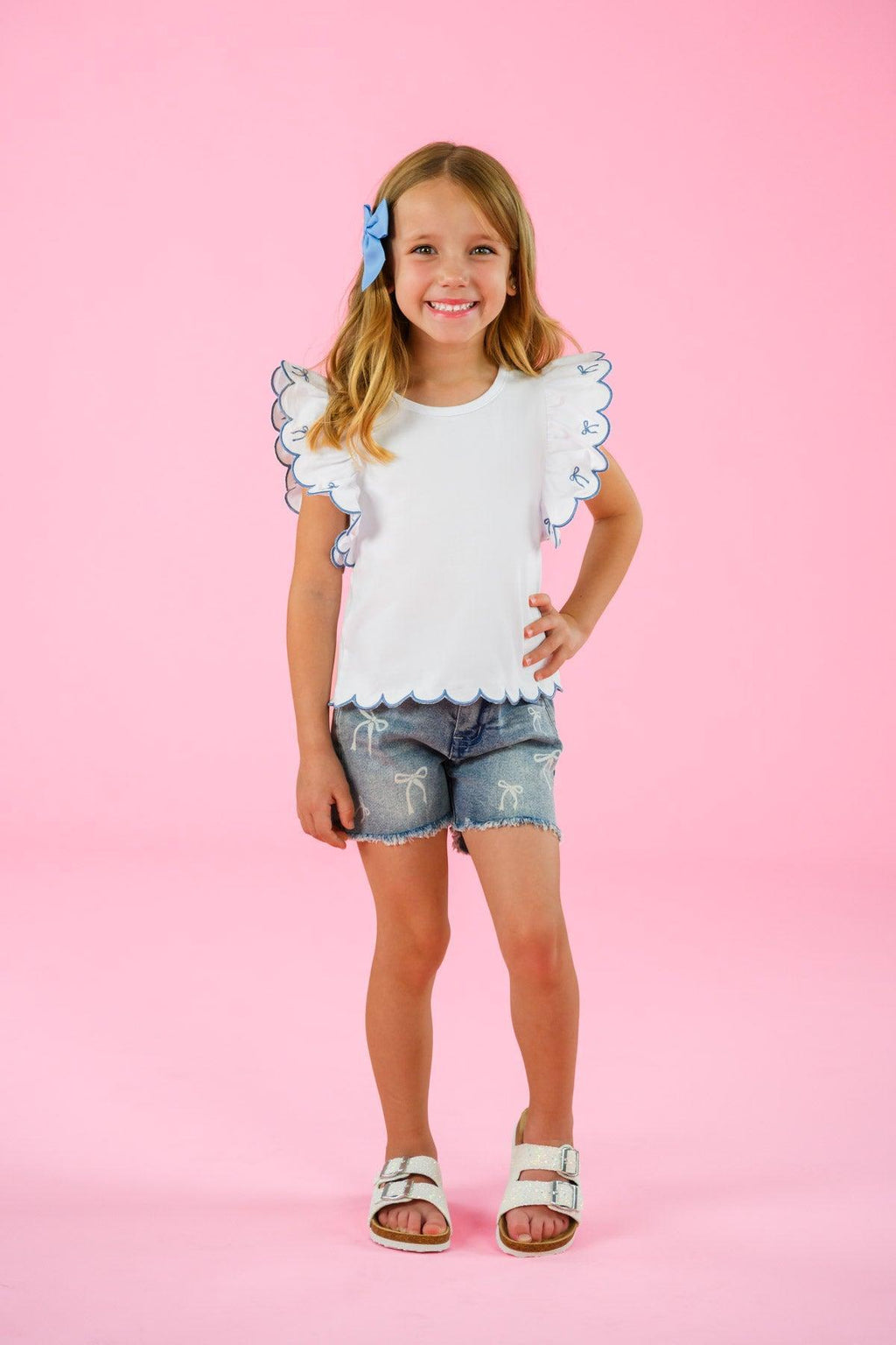 White & Blue Bow Denim Short Set - 6-12 Months - White ruffled sleeve top with blue bow accents paired with distressed denim shorts.