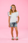 White & Blue Bow Denim Short Set - 6-12 Months - White sleeveless top with scalloped edges and eyelet trim, paired with distressed blue denim shorts and a blue bow hair.