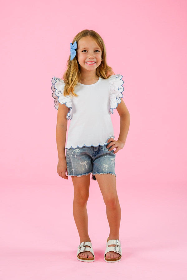 White & Blue Bow Denim Short Set - 6-12 Months - White sleeveless top with scalloped edges and eyelet trim, paired with distressed blue denim shorts and a blue bow hair.