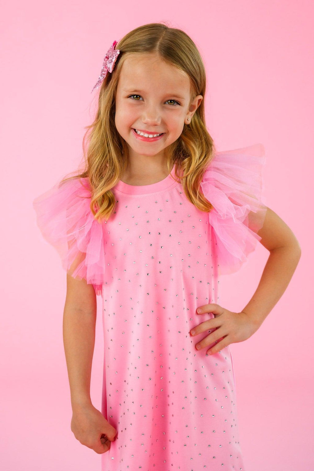 Pink Rhinestone Dress - 6-12 Months - Pink dress with sheer ruffled sleeves and scattered rhinestones, worn by smiling girl.