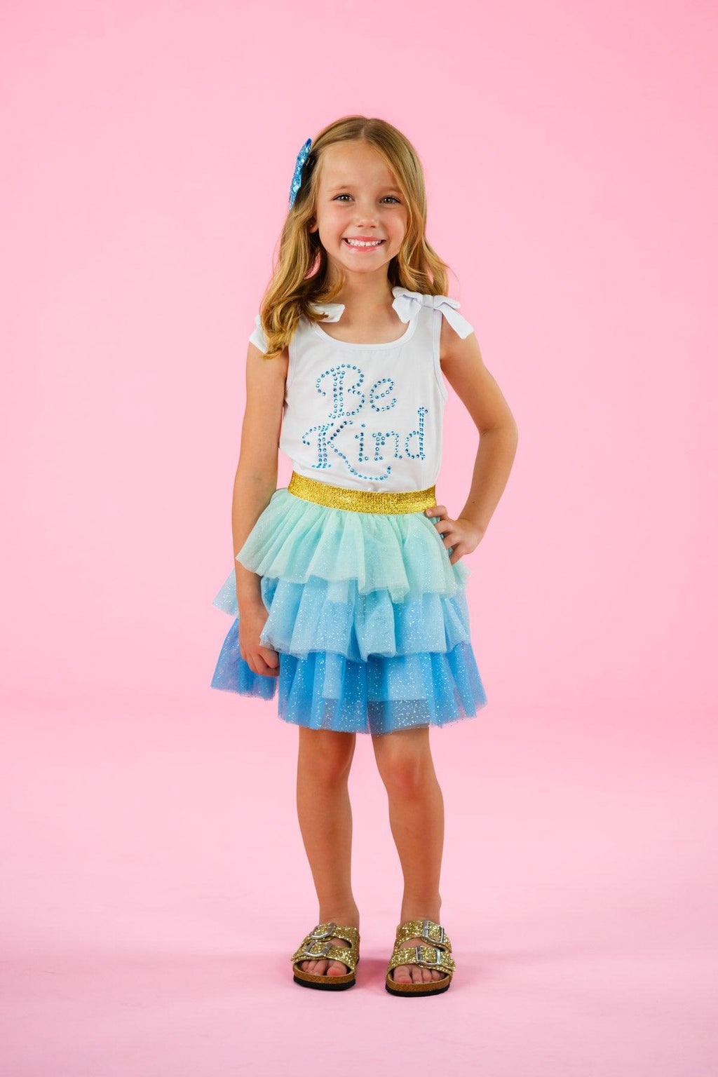 "Be Kind" Glitter Tutu Skirt Set - 6-12 Months - Girl wearing white short-sleeve shirt with "Be Kind" text and layered glitter blue and mint tutu skirt.