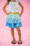 "Be Kind" Glitter Tutu Skirt Set - 6-12 Months - White sleeveless top with blue glitter "Be Kind" text paired with a layered blue and mint tutu skirt with a gold waistband.