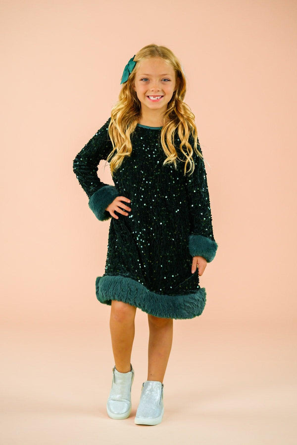 Sparkle Plush Sequin Long Sleeve Dress - Green / 6-12 Months - Black plush long sleeve dress with teal sequin trim on cuffs and hem, worn by young girl.