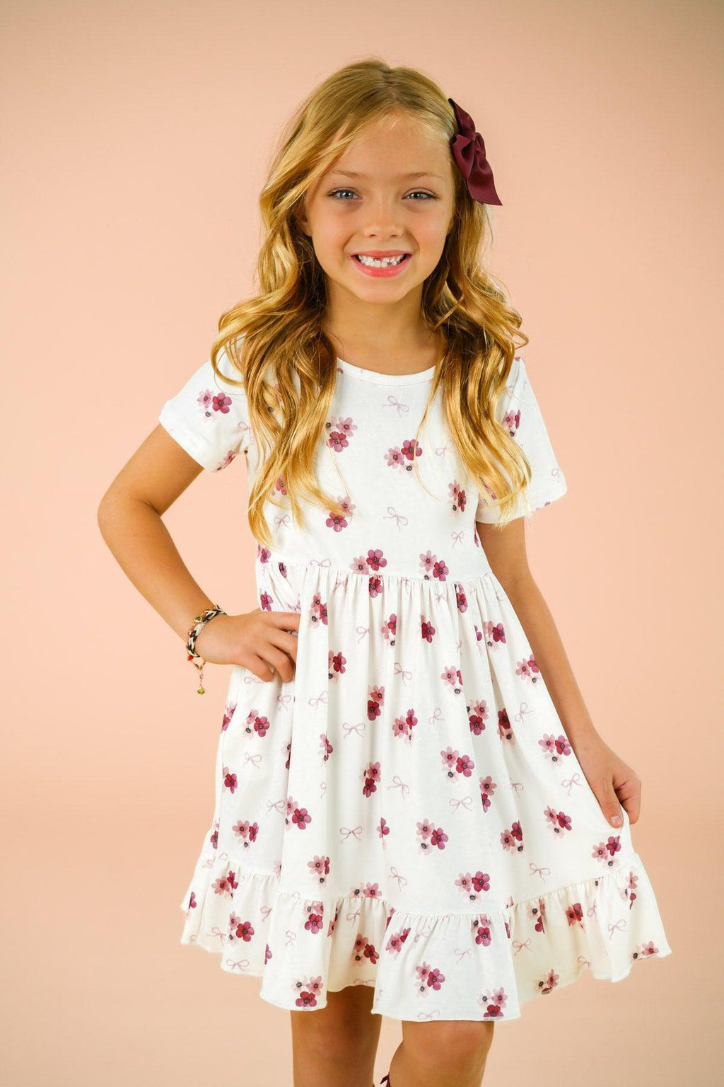 Pink Flowers & Bows Dress - 6-12 Months - White short-sleeve dress with pink and purple floral print, ruffled hem, and a matching pink bow in hair.