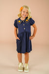 Faux Denim Pumpkin Dress - 6-12 Months - Navy blue faux denim dress with short puff sleeves, orange pumpkin appliques on collar, front buttons, and a gathered skirt.