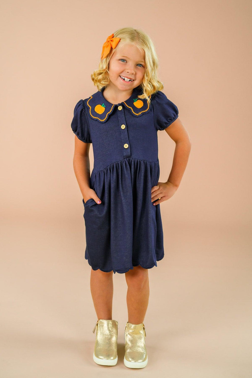Faux Denim Pumpkin Dress - 6-12 Months - Navy blue faux denim dress with short puff sleeves, orange pumpkin appliques on collar, front buttons, and a gathered skirt.