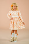 Orange Plaid Bow Dress - 6-12 Months - Orange and white plaid long-sleeve dress with white waistband and full skirt, worn by young girl with matching orange bow.