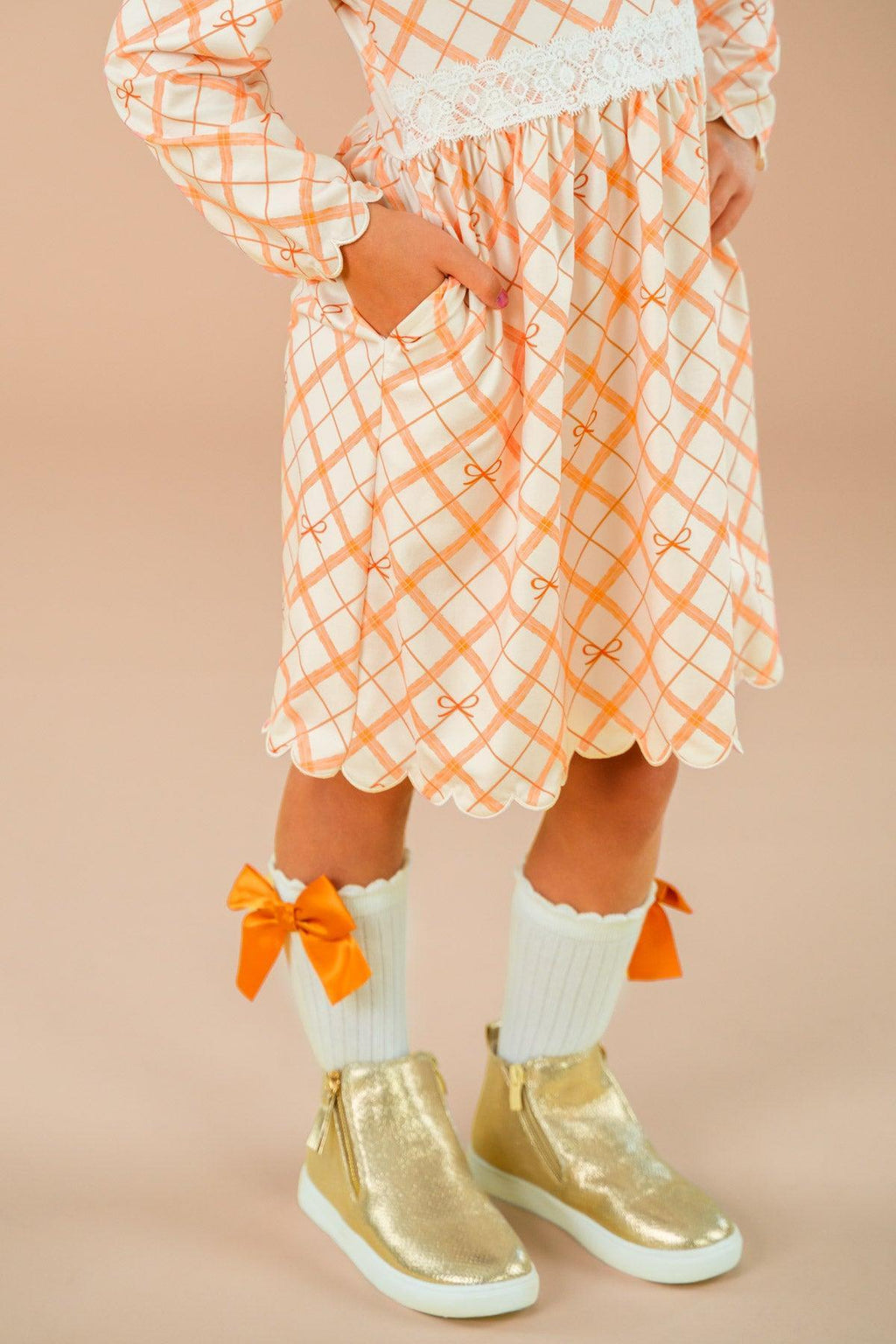 Orange Plaid Bow Dress - 6-12 Months - Orange and white plaid dress with long sleeves and a bow detail at the waist.