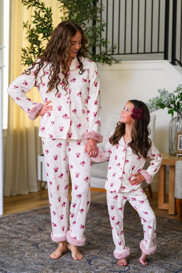 Mom & Me - Fuzzy Flower & Bow Pajamas - CHILD-6-12 Months - Cream-colored fuzzy pajamas with pink floral prints and matching bows, worn by a mother and daughter pair.