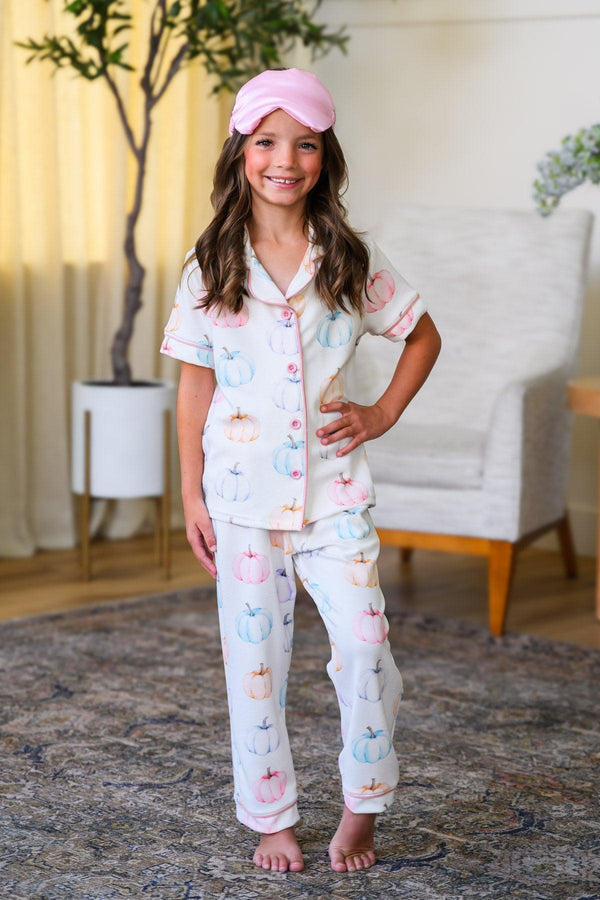 Mom & Me - Pastel Pumpkin Waffle Knit Pajamas - CHILD-6-12 Months - Girl wearing pastel pink and cream waffle knit pajamas with pumpkin and leaf patterns, short-sleeve button-up top and long.