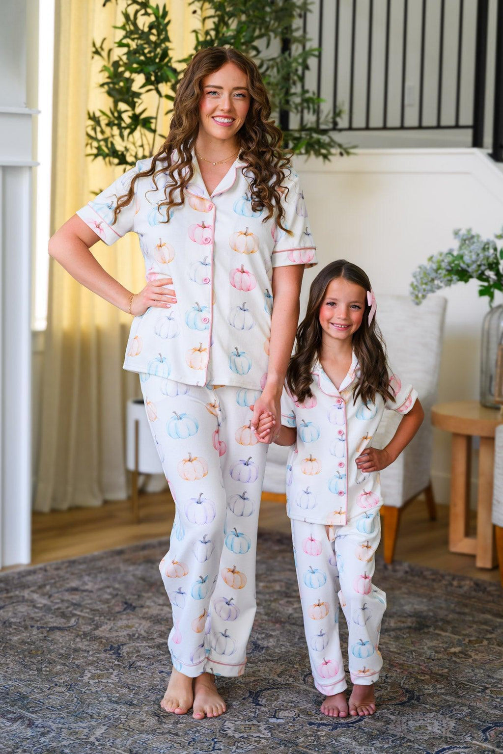 Mom & Me - Pastel Pumpkin Waffle Knit Pajamas - CHILD-6-12 Months - Cream-colored waffle knit pajamas with pastel pumpkin print, button-up top and matching pants, worn by mother and daughter.