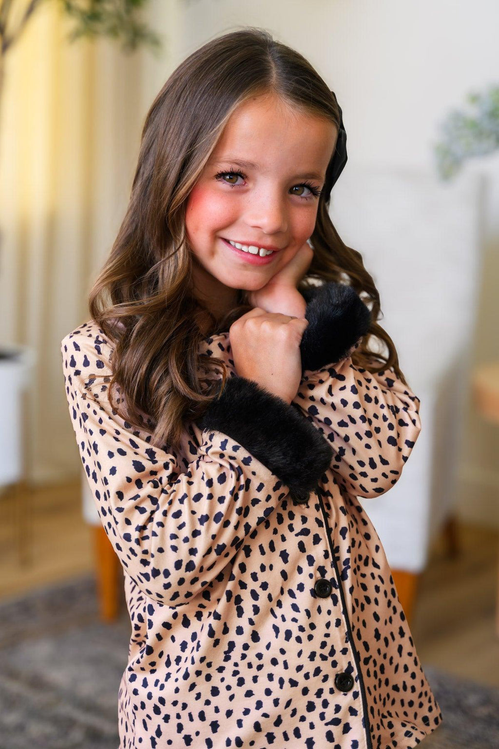 Mom & Me - Fuzzy Cheetah Pajamas - CHILD-6-12 Months - Child wearing fuzzy cheetah-print pajamas with black cuffs and collar, smiling indoors.