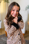 Mom & Me - Fuzzy Cheetah Waffle Knit Pajamas - CHILD-6-12 Months - Brown fuzzy cheetah print waffle knit long-sleeve pajama top with black furry cuffs worn by a smiling child.