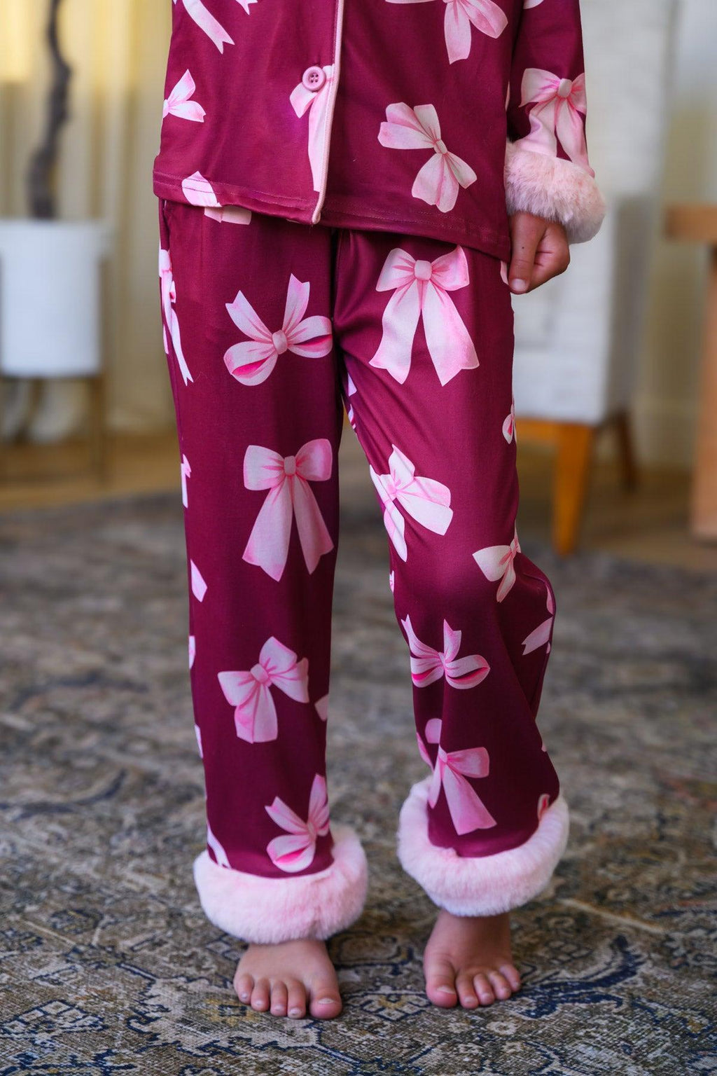 Mom & Me - Fuzzy Pink Bow Pajamas - CHILD-6-12 Months - Burgundy pajama pants with large pink fuzzy bows and pink fuzzy cuffs.