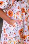 Mom & Me - Floral Fall Watercolor Dress - CHILD-6-12 Months - Cream dress with orange and peach floral watercolor print, smocked waist, and side pocket detail.