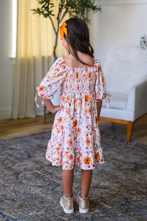 Mom & Me - Floral Fall Watercolor Dress - CHILD-6-12 Months - Cream-colored knee-length dress with orange floral watercolor print, puff sleeves, and smocked bodice.