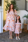 Mom & Me - Floral Fall Watercolor Dress - CHILD-6-12 Months - Cream knee-length dress with orange floral watercolor print, puffed sleeves, and tiered skirt.