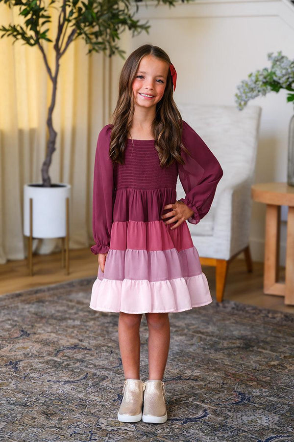 Mom & Me - Purple Ruffle Ombre Dress - CHILD-6-12 Months - Purple long-sleeve dress with tiered ruffle ombre skirt in shades of purple and pink, worn with white shoes.