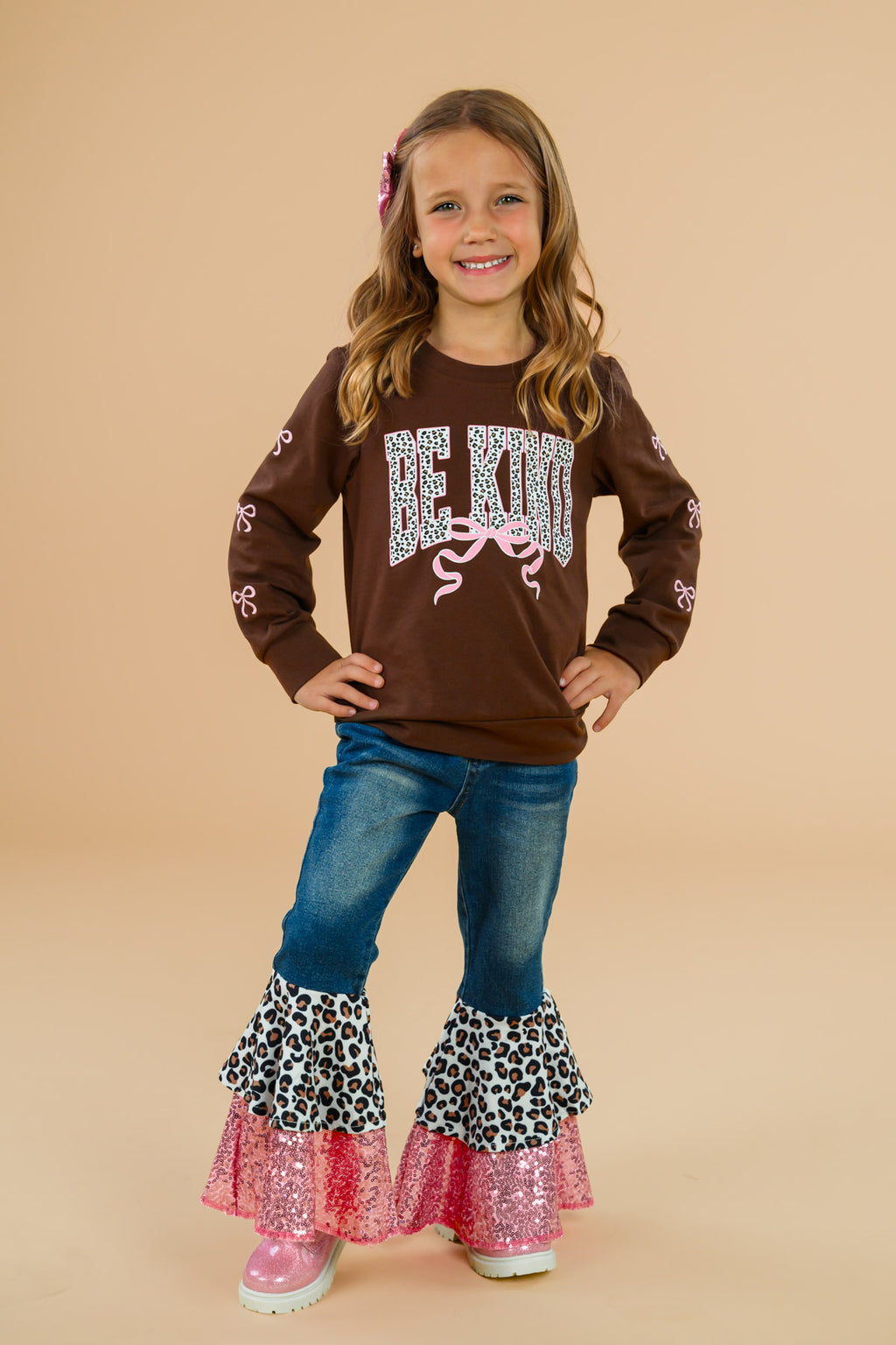 "Be Kind" Cheetah Denim Bell Bottom Set - 6-12 Months - Brown long-sleeve shirt with "Be Kind" text paired with denim bell bottom pants featuring layered cheetah and pink ruffle.