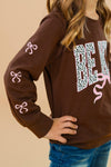 "Be Kind" Cheetah Denim Bell Bottom Set - 6-12 Months - Brown long-sleeve sweatshirt with "BE KIND" cheetah print lettering and pink bow accents on sleeves and front.