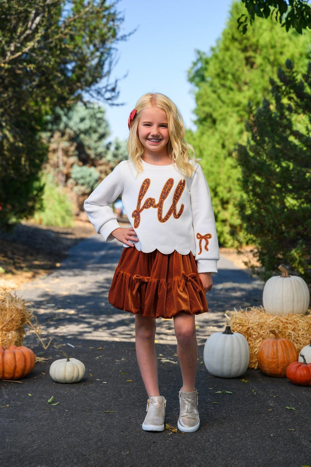"Fall" Rust Floral Suede Skirt Set - 6-12 Months - Cream long-sleeve top with rust "fall" text paired with rust suede ruffled skirt and white sneakers.