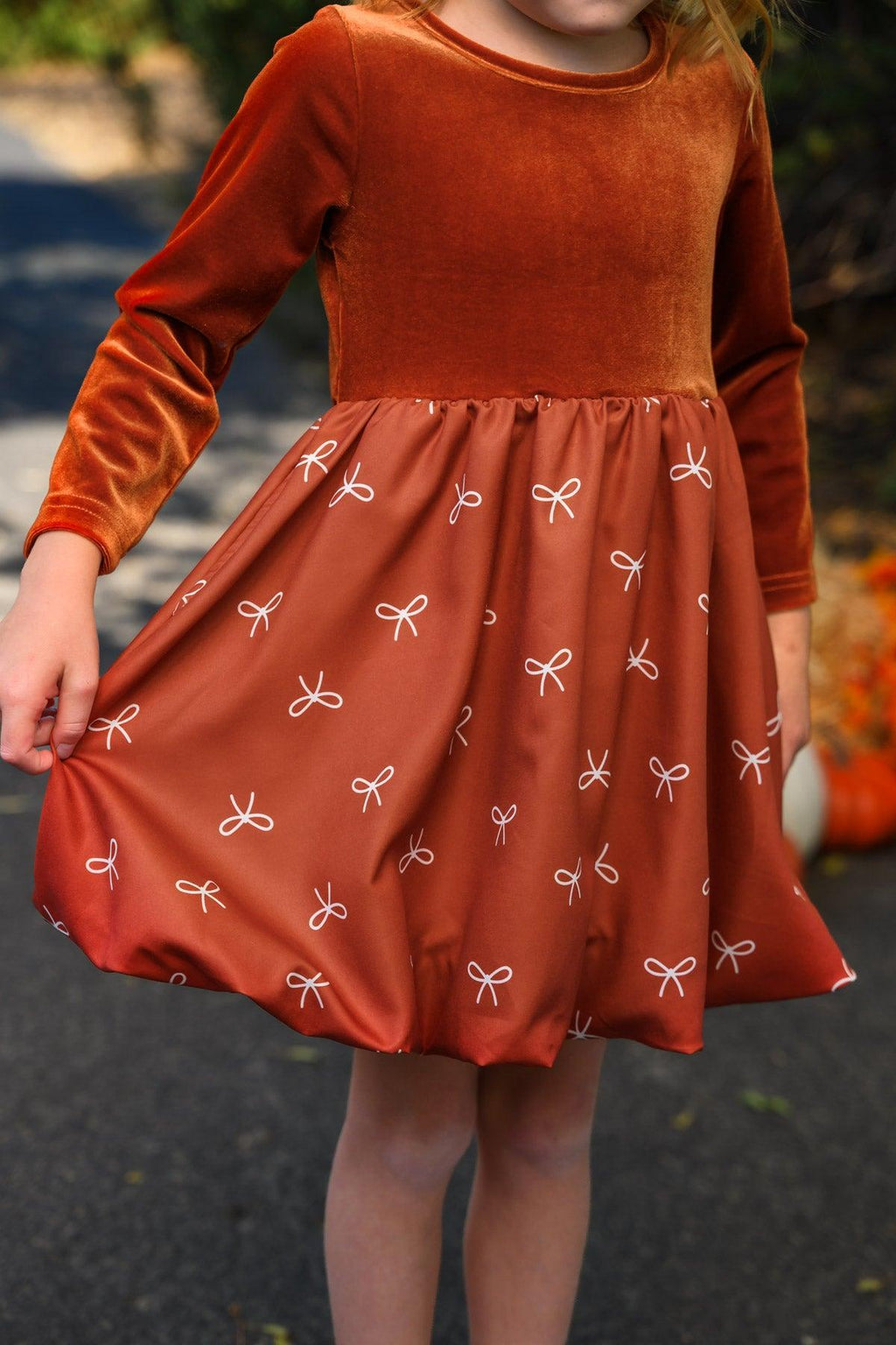 Rust Velvet Bow Dress - 6-12 Months - Rust velvet long-sleeve dress with bow-patterned gathered skirt and round neckline.