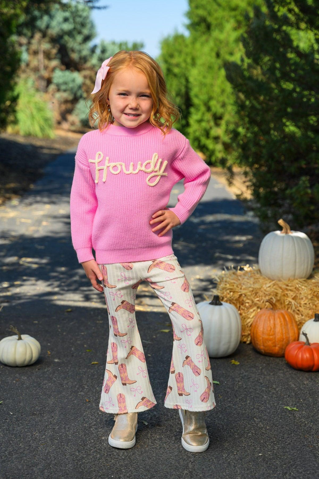 "Howdy" Pink Cowgirl Bell Bottom Set - 6-12 Months - Pink long-sleeve sweater with "Howdy" text paired with white bell-bottom pants featuring a pink Western print.