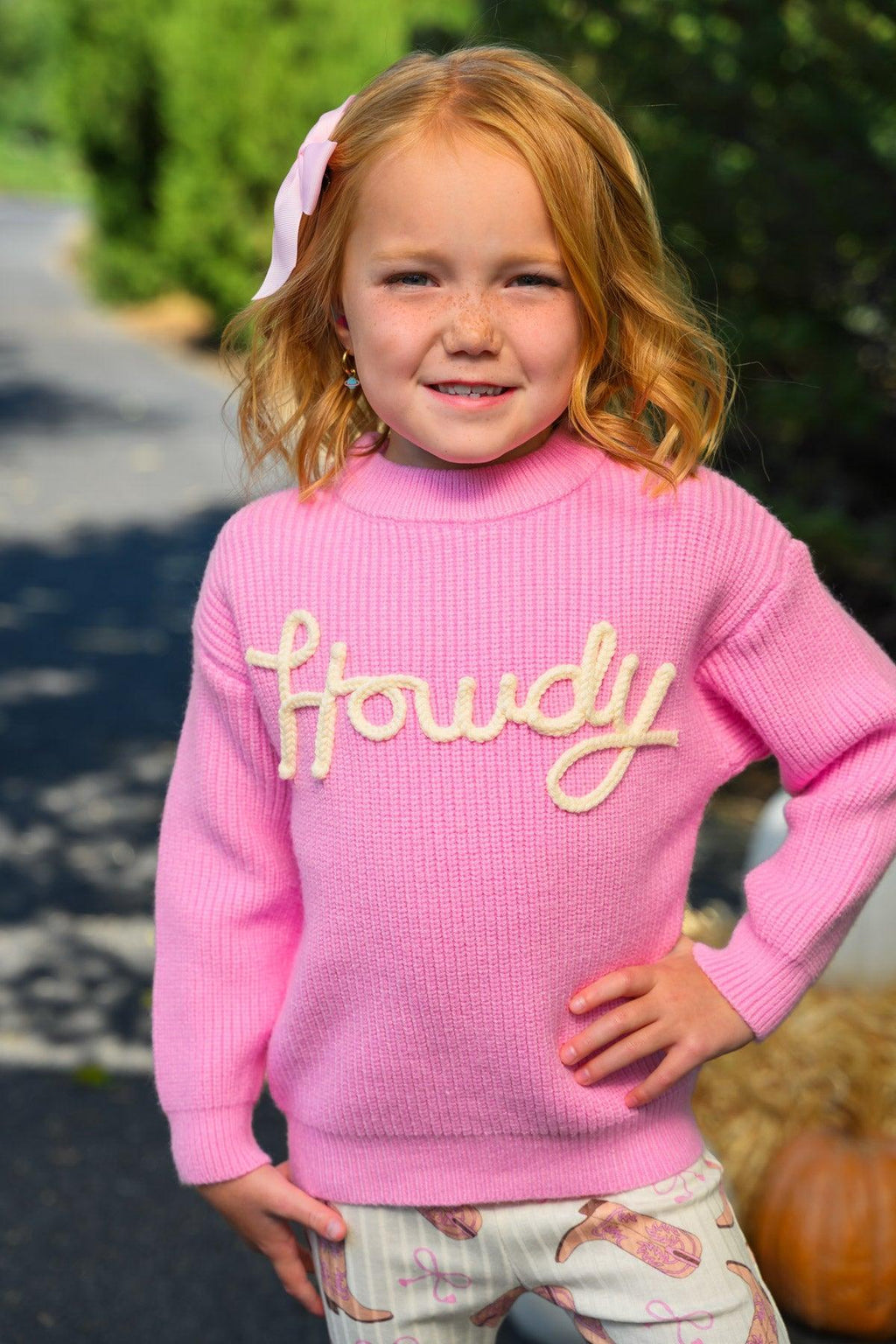 "Howdy" Pink Cowgirl Bell Bottom Set - 6-12 Months - Pink knit sweater with "Howdy" in cream cursive, paired with cream bell-bottom pants featuring pink accents.