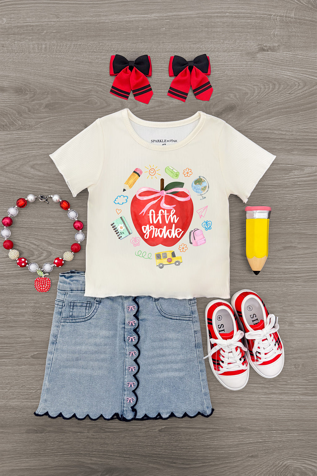 "Pre-K - Fifth Grade" Apple Denim Skirt Set - PRE-K / 2T - Cream short-sleeve tee with apple graphic, light denim skirt with scalloped hem, red sneakers, red hair bows, and colorful.