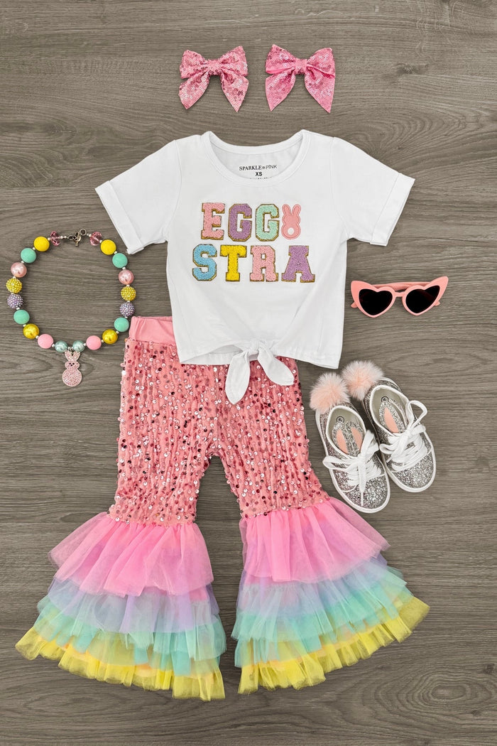 "Eggstra" Pink Sequin Tulle Bell Bottom Set - 3XS-6-12 Months - White short-sleeve tee with colorful "EGGSTRA" text, pink sequin bell bottoms with layered pink, blue, and yellow tulle.