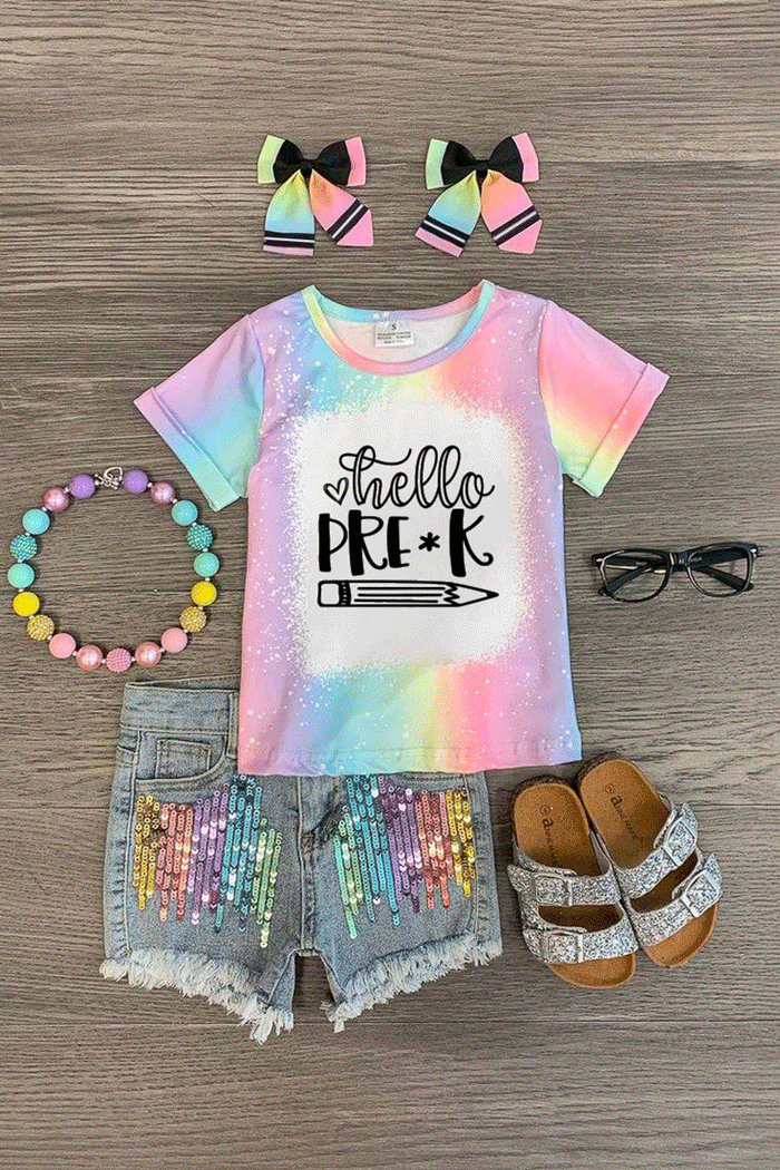 "Hello Pre-K - 6th Grade" Rainbow Denim Short Set - PRE-K / 2T - Tie-dye pastel t-shirt with "Hello Pre-K" text, sequin rainbow shorts, matching hair bows, colorful bead bracelet, glasses,.
