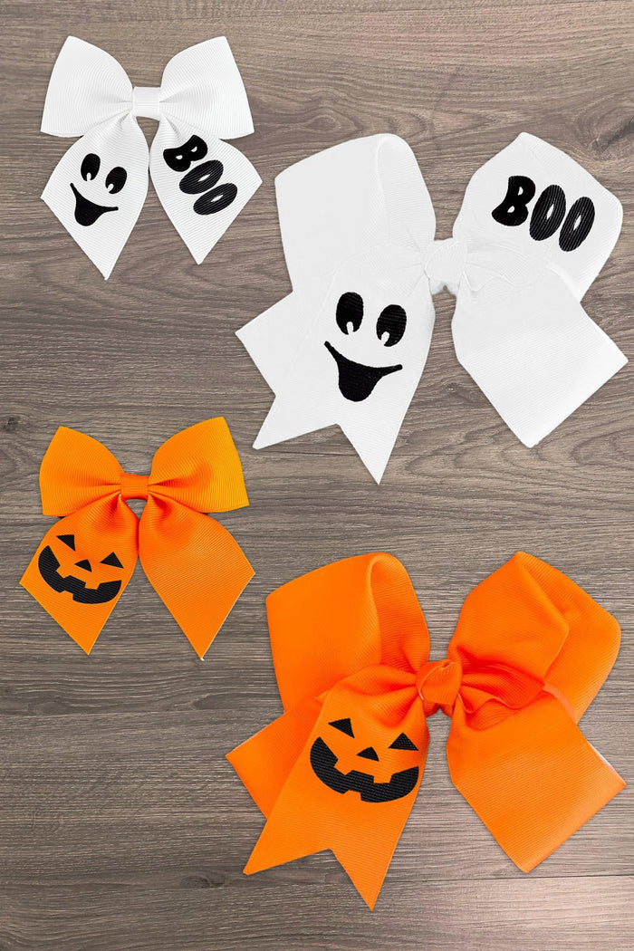 Halloween Bows - 3 inches / White - White and orange Halloween bows with ghost faces, "BOO" text, and jack-o'-lantern designs on wood background.