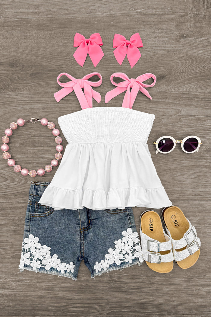 White Floral Lace Denim Short Set - 6-12 Months - White strapless ruffled top with pink bows, floral lace denim shorts, white sandals, pink beaded necklace, and round.