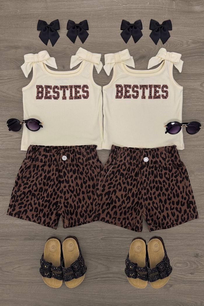 "Besties" Cheetah Denim Short Set - 6-12 Months - Cream sleeveless tops with "BESTIES" text paired with cheetah print denim shorts, black hair bows, sunglasses, and black.