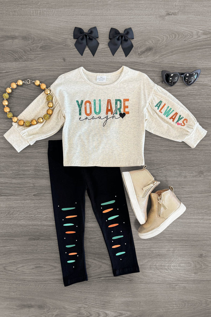 "You Are Enough... Always" Legging Set - 3XS-6-12 Months - Cream long-sleeve top with multicolor "You Are Enough Always" text and black leggings with colorful slits, paired with gold.