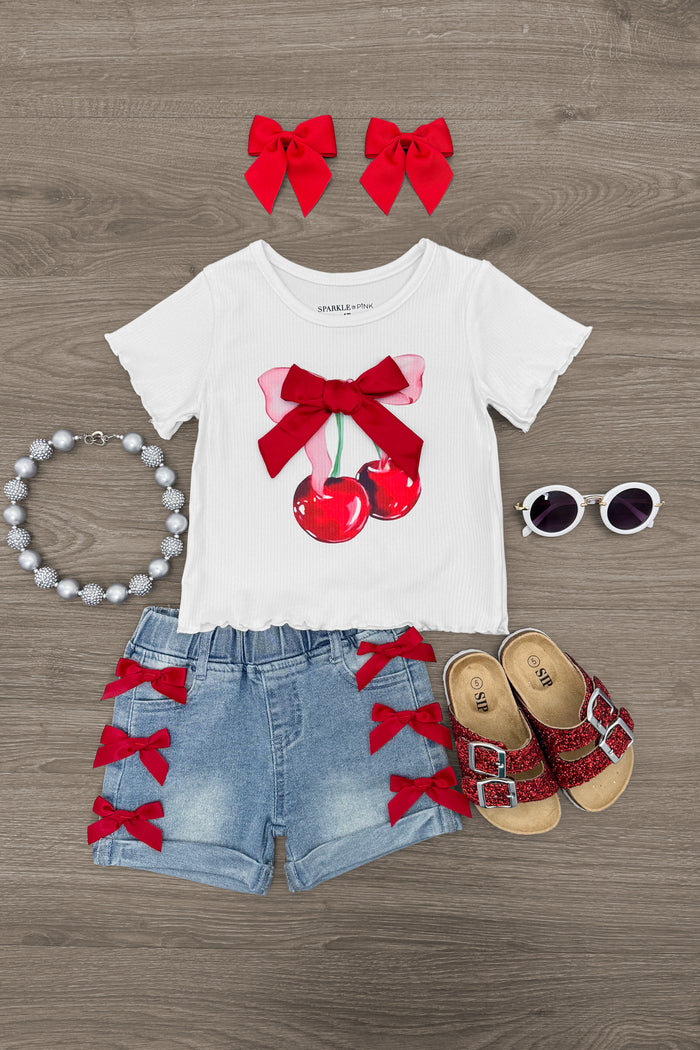 Cherry Bow Denim Short Set - 6-12 Months - White short-sleeve tee with red cherry and bow graphic, light denim shorts with red bows on sides.