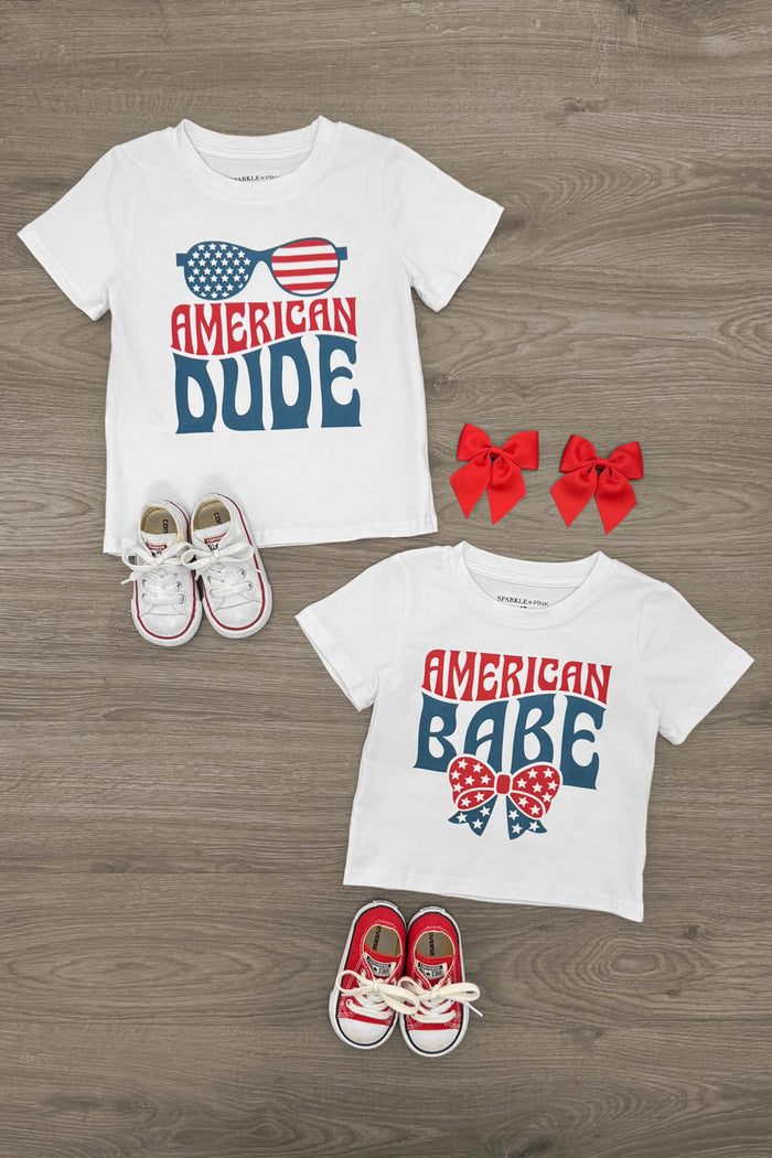 "American Babe & Dude" Top - Boy Or Girl! - Girl / 6-12 Months - White toddler t-shirts with "American Dude" and "American Babe" patriotic text designs, paired with red and white toddler.