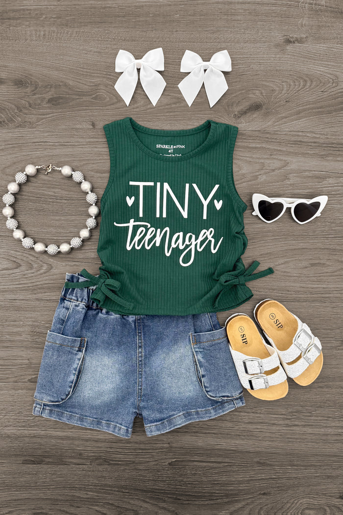 "Tiny Teenager" Denim Short Set - 6-12 Months - Green sleeveless tank top with "Tiny Teenager" text, denim shorts, white sandals, white bow clips, beaded bracelet, and.