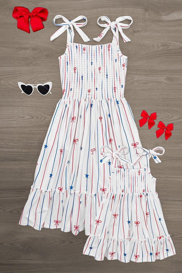 Mom & Me - Stars & Bows Stripe Dress - CHILD-6-12 Months - White sleeveless dress with red and blue star and stripe print, adjustable shoulder ties, and ruffled hem.