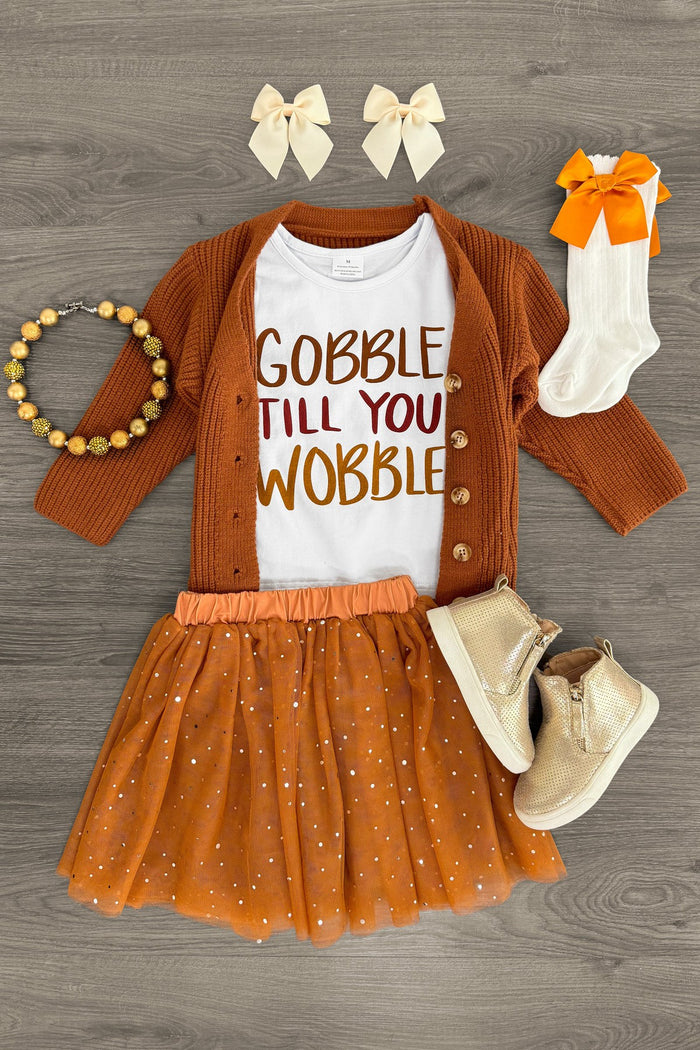 "Gobble Till You Wobble" Cardigan Skirt Set - 3 Piece - 3XS-6-12 Months - Toddler set with rust cardigan, white bodysuit reading "Gobble Till You Wobble," rust tulle skirt, cream booties, socks, and .