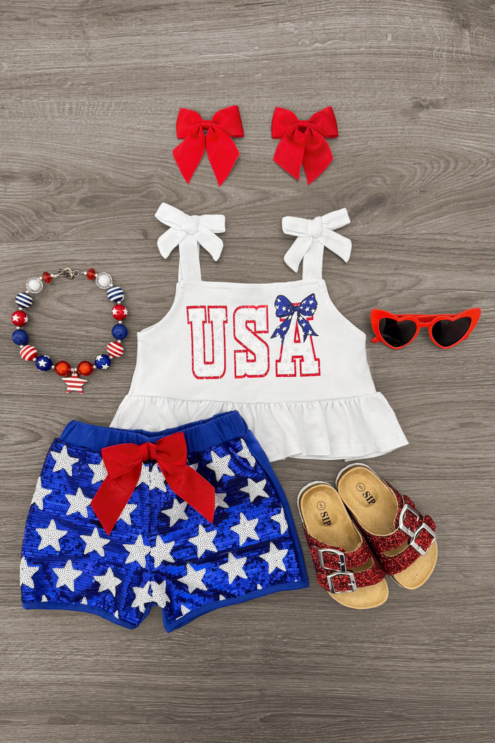 "USA" Tank Sequin Short Set - 3-6 Months - White tank top with sequined USA and bow, blue star shorts with red bow, red sandals and sunglasses, star bead bracelet, red .