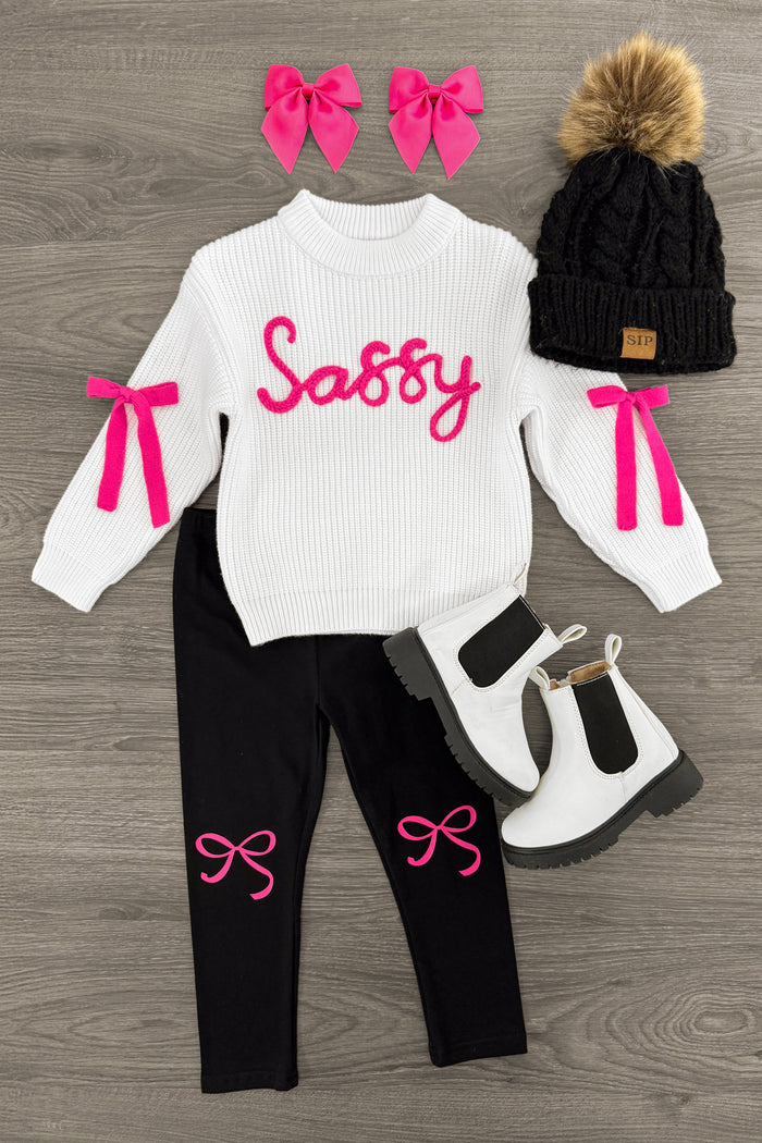 "Sassy" White Knit Sweater Legging Set - 3XS-6-12 Months - White knit sweater with pink "Sassy" text and bow details, black leggings with pink bows, black knit hat with pom-pom, white .
