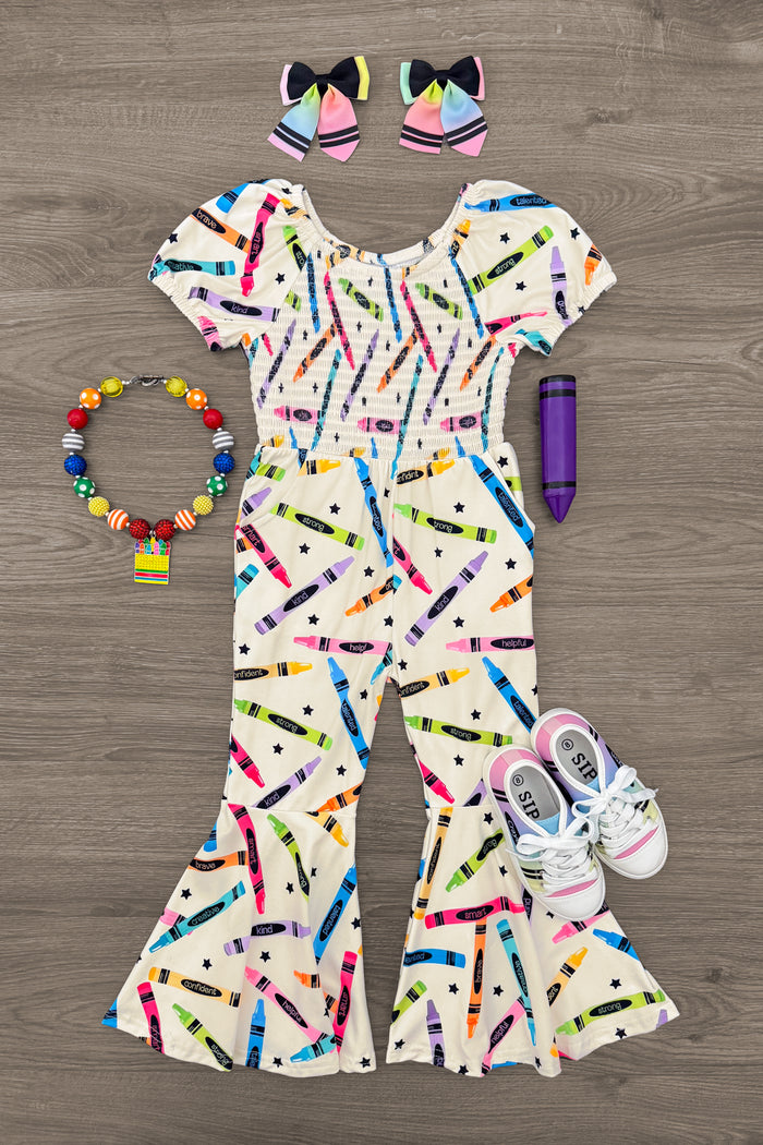 Crayons & Stars Flare Jumpsuit - 3T - Cream flare jumpsuit with colorful crayon and star print, paired with matching bow hair clips and white sneakers.